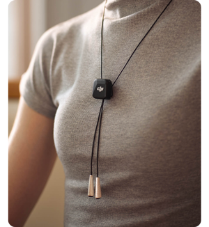 Person wearing grey t-shirt with DJI Mic Mini on lanyard