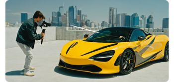 filmmaker recording video of yellow mclaren car using DJI ronin gimbal