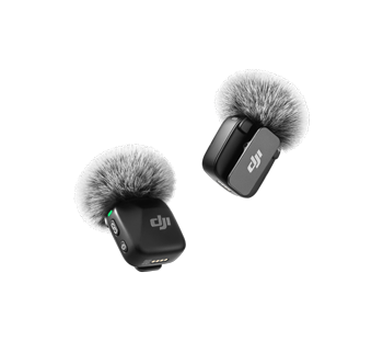 Image of two DJI Mic Mini Transmitters with windscreens attached floating in the air