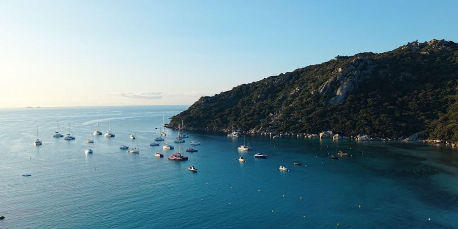 dji mini 5 pro sample image of a boats near a cliff
