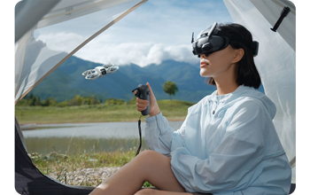 Female drone pilot flying DJI Neo with DJI motion controller and Goggles