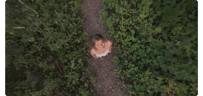 animated gif of woman standing on dirt path with Rocket flight path