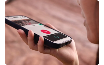 Woman holding smartphone with Voice control application open