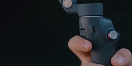 someone activating the dji osmo mobile dual lens boost