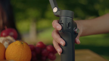 someone pressing the dji osmo mobile switch