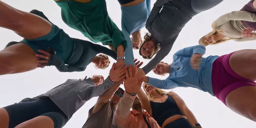 sample image from the dji osmo nano of a group of people putting their hands together