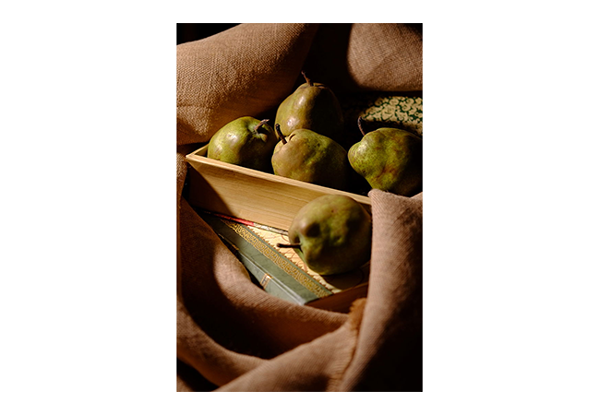 sample image of pears in a wooden create taken with the fujifilm x lens