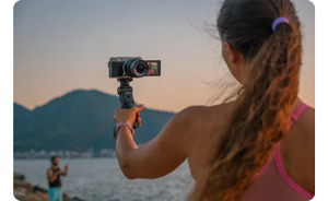 female vlogger holding Fujifilm X-M5 with mini tripod