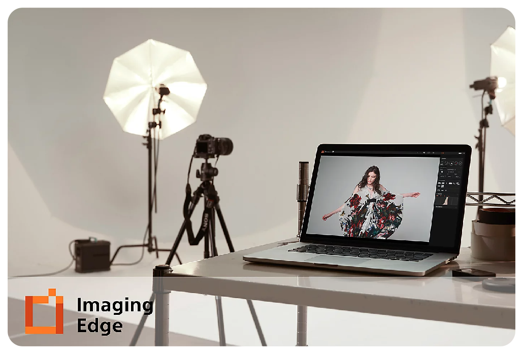 Sony A7C setup with laptop in photography studio with standing photography lights in the background