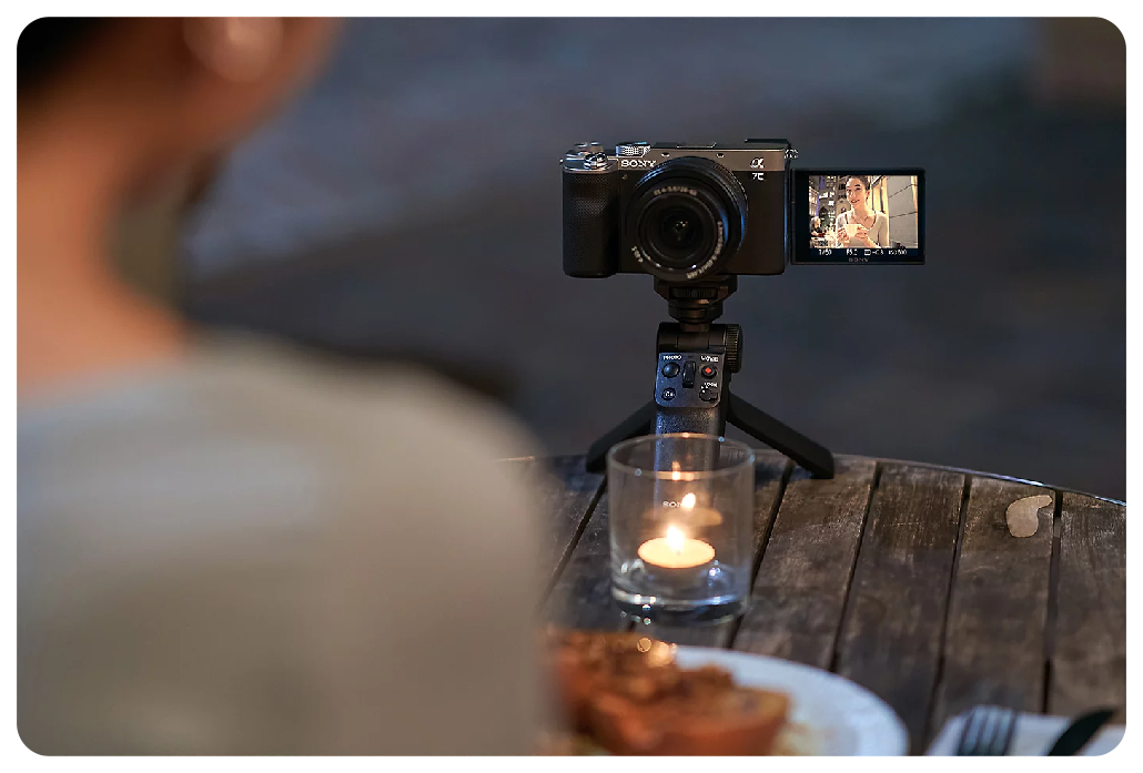 Sony A7C Vlogging setup sat on wooden table with tealight candle