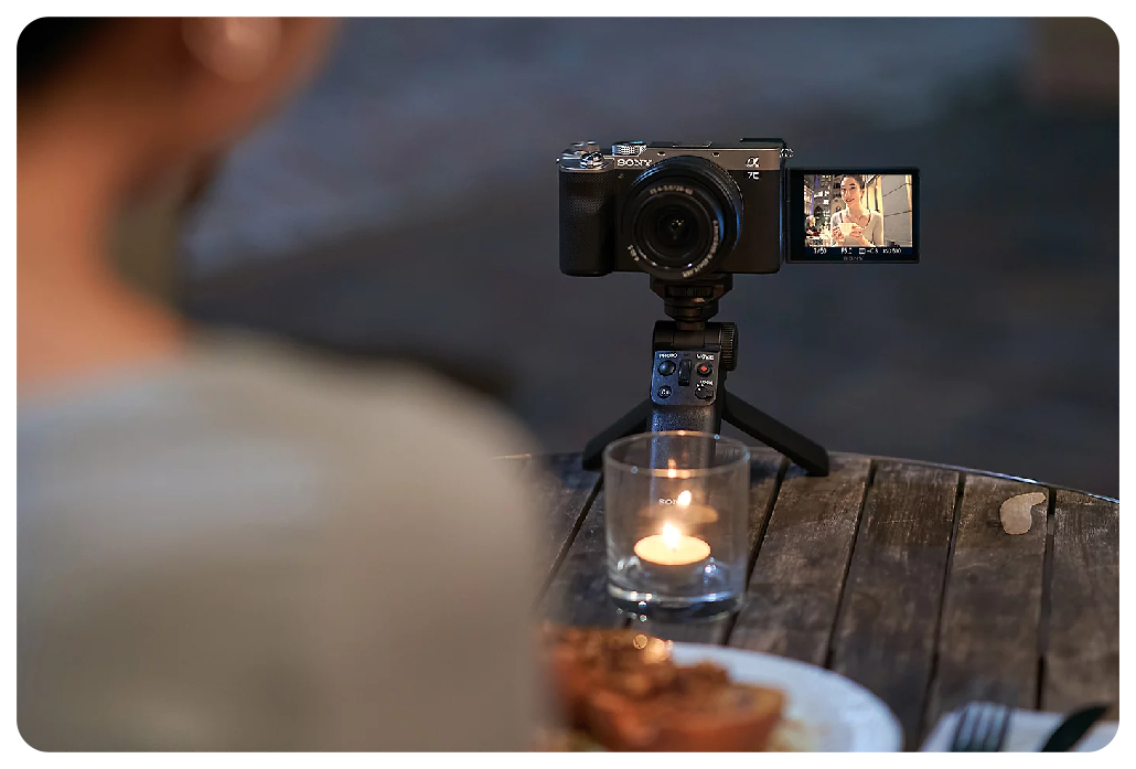 Sony A7C Vlogging setup sat on wooden table with tealight candle
