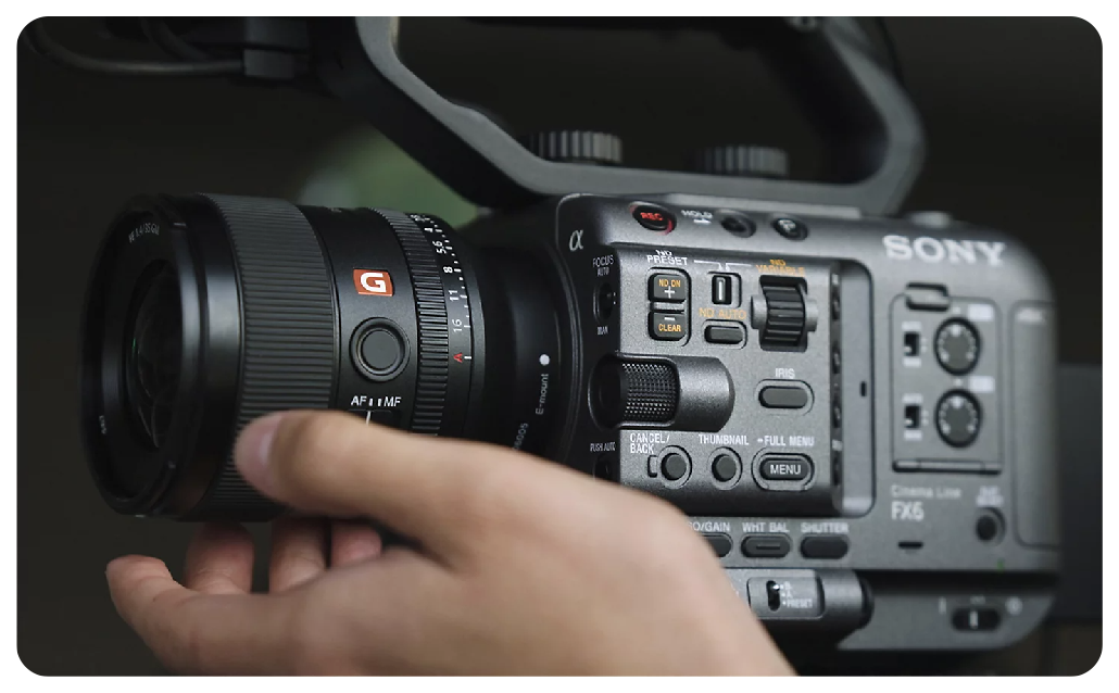 Filmmaker adjusting lens on Sony FX6 professional camera