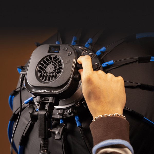 someone adjusting the controls on the amaran light