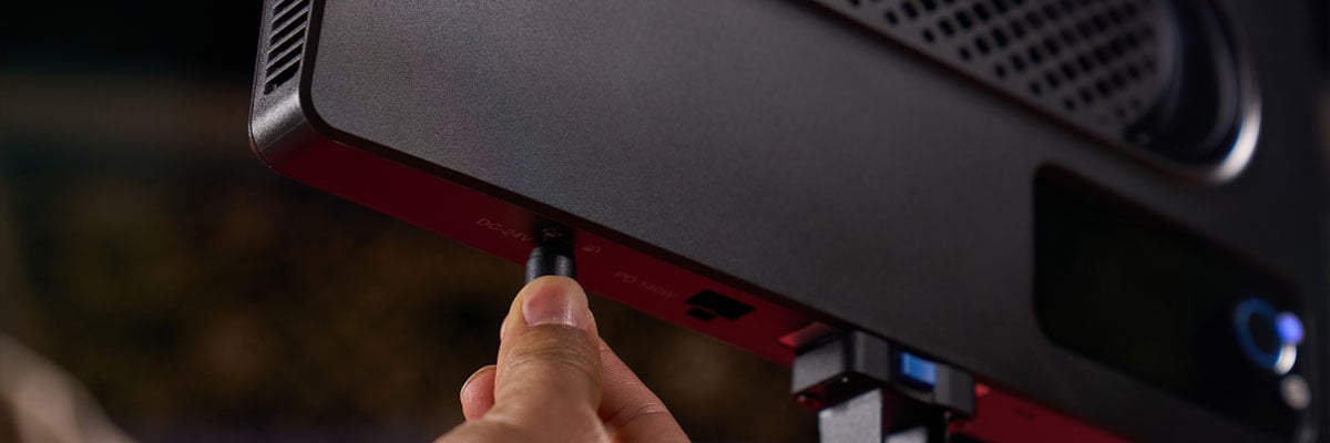 close up of someone connected a power cable to the amaran light