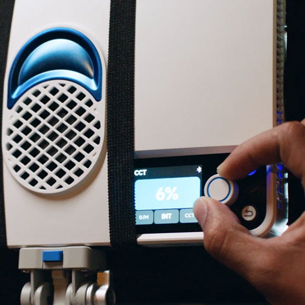 somone adjusting the controls on the amaran light