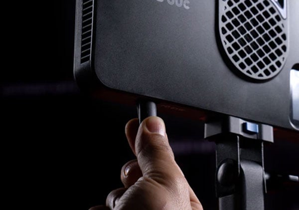 someone connecting a power cable to the pano 60c