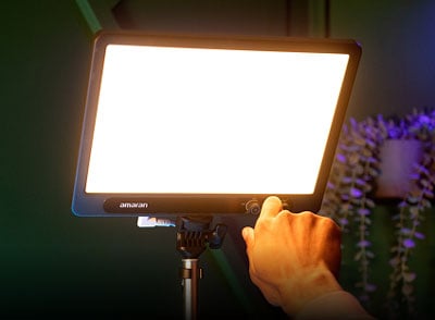someone adjusting the amaran verge light using the front facing controls