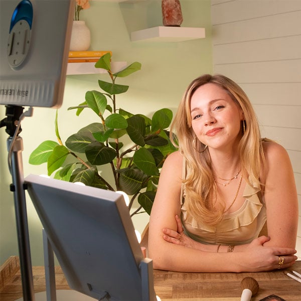 a woman sat at a make-up desk using the amaran verge panel light