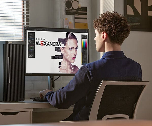 designer editing a photo of a woman using a pro art monitor