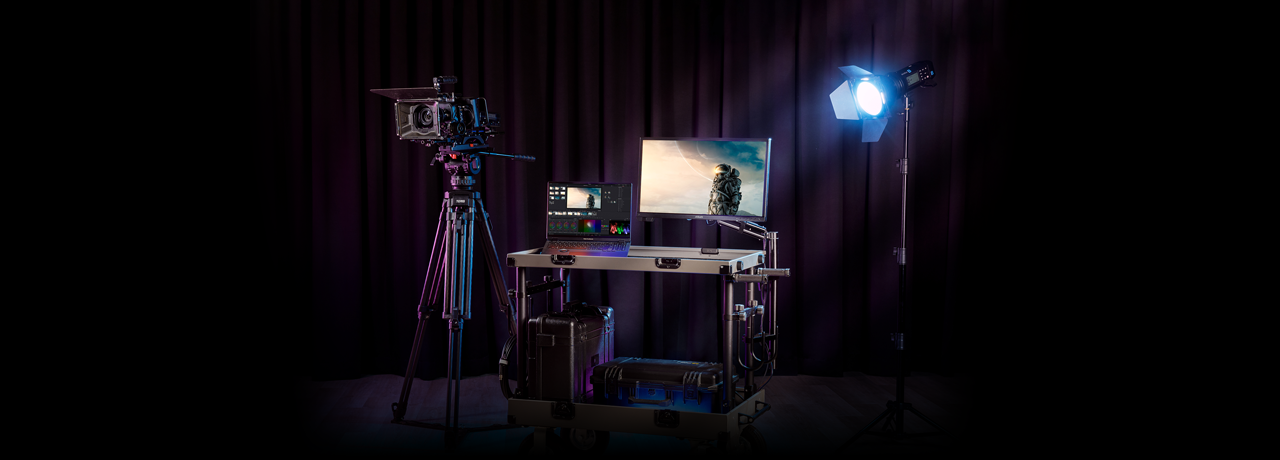 ASUS ProArt PA24US Monitor Hero Banner with DIT Cart, Camera, Pro Art Laptop and studio Light infront of a stage curtain 
