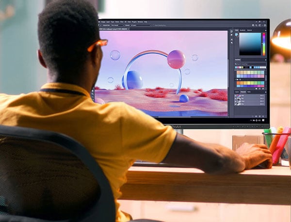 a man sat a desk going different ai variations of an image on a asus proart display