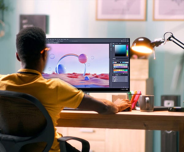 over the shoulder view of a designer using the asus proart display with photoshop