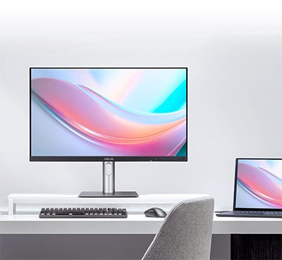 asus pro art display on a desk with a mac book