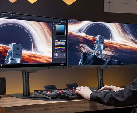 Video editor reviewing footage with Dual pa27usd Monitors