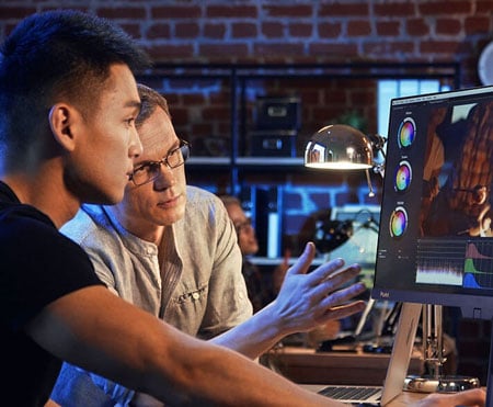 two video colourists reviewing footage on ASUS ProArt monitor
