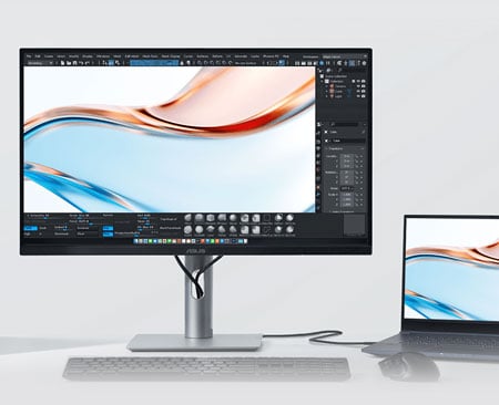 macbook connected to the asus pro art monitor with a mouse and keyboard