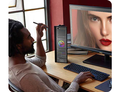 Image of photographer editing photograph of female model with red lipstick on multiple ProArt monitors