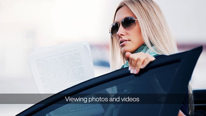 image of blonde woman standing behind car door wearing sun glasses