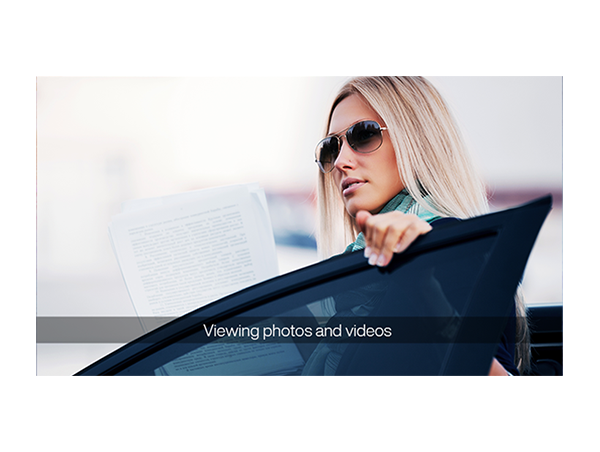 image of blonde woman standing behind car door wearing sun glasses