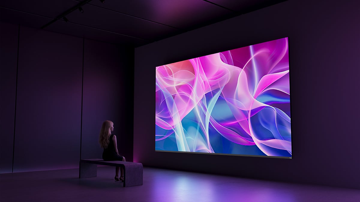a woman at down looking at a asus pro art cinema display being used during an art exhbit