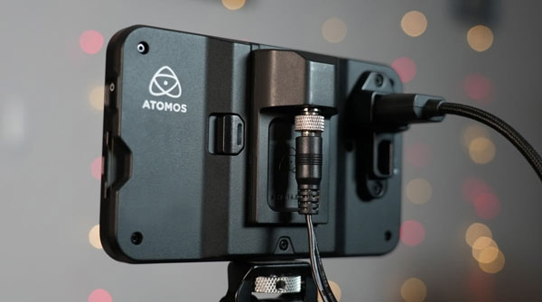 power cable connected to the back of the atomos shinobi 7