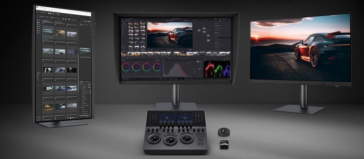 three benq monitors on a desk with a davinci resolve panel