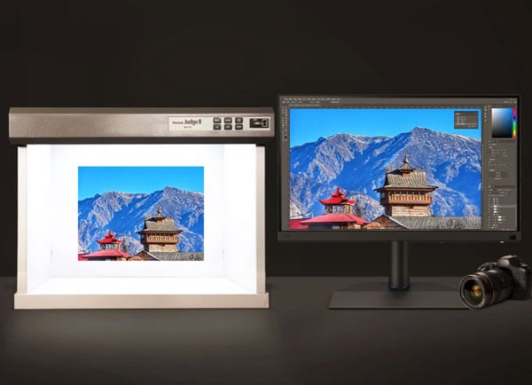 benq monitor on a desk with a camera and lightbox