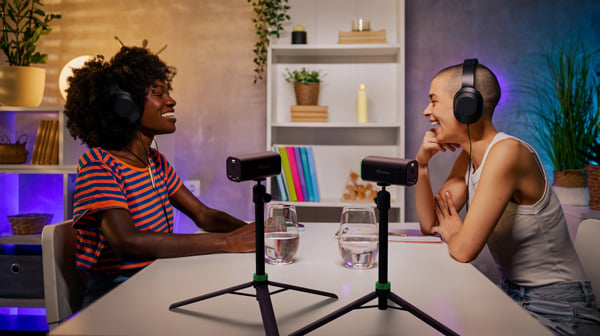 two people using the maki cameras on tripods for filming a podcast