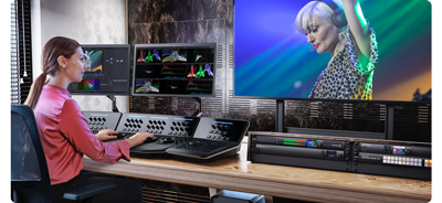 Image of colourist grading footage with DaVinci Resolve advanced panel and HDR displays