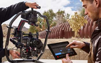 camera operator connecting URSA Cine 12K camera to DJI Ronin gimbal and using bluetooth control on iPad