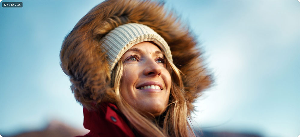 an image of a woman wearing a red jacket with a faux-fur trim hood and a knitted beanie showing aspect ratio comparison