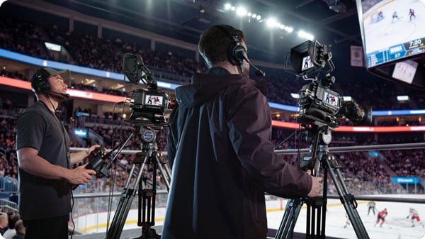 someone filming a hockey game using  a blackmagic ursa cine