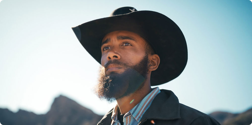 a man wearing a cowboy-style hat and jacket