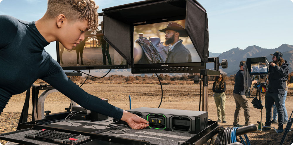 someone using the blackmagic media dock on a cowboy movie set
