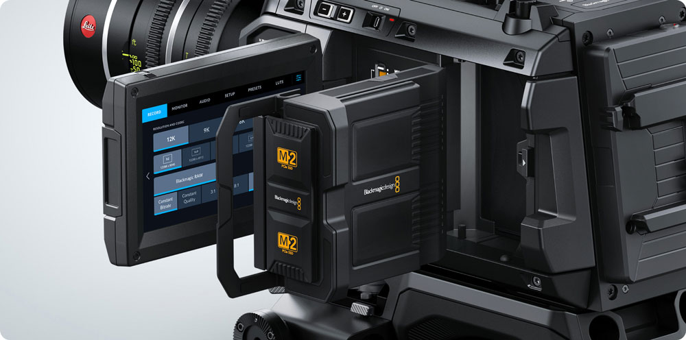 blackmagic media module being inserted into the ursa cine camera