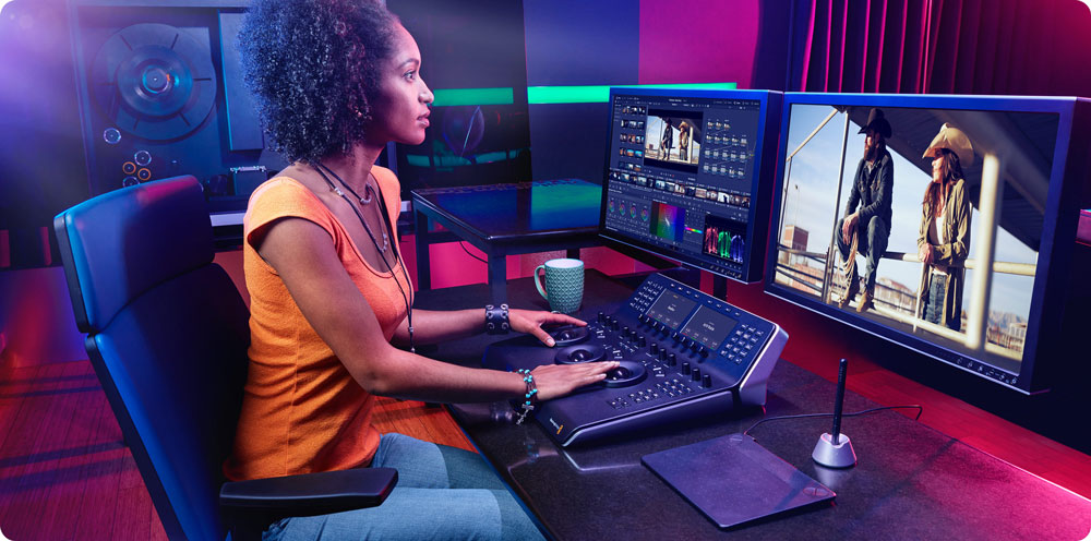 someone editing footage using blackmagic davinci resolve studio sat at a desk