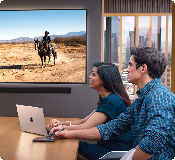 people sat in a meeting room watching a live stream from the blackmagic ursa cine