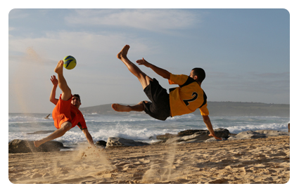 sample image of 2 men playing football on a beach taken with the canon ef 24 lens
