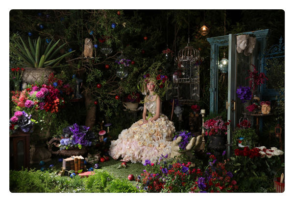 sample photo of a woman in a white floral dress in a florist shop taken on the canon ef 24 lens