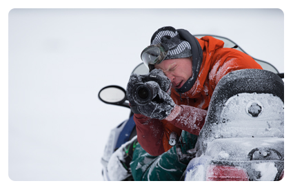 a man using the canon ef 24 lens on a snowmobile